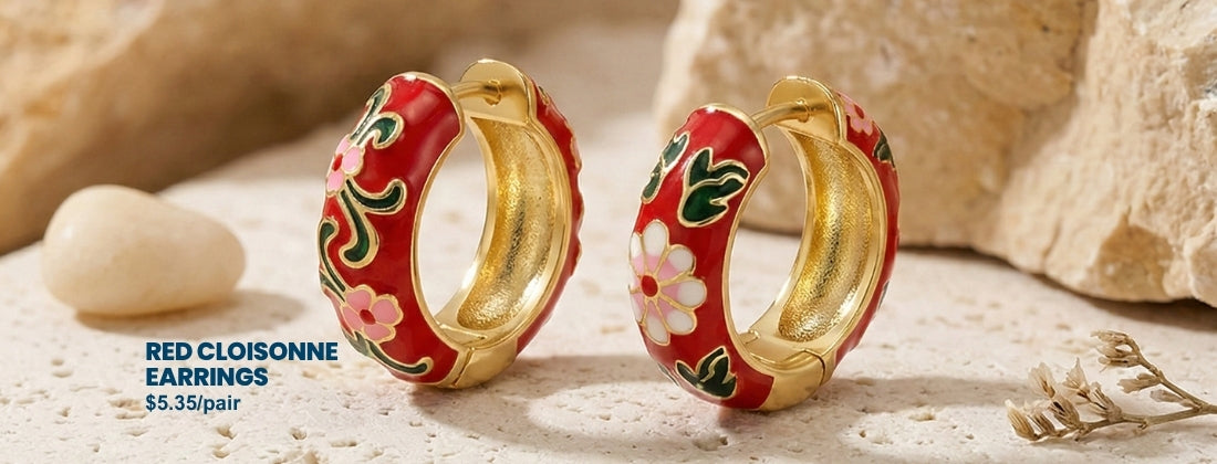 Red cloisonne earrings with gold accents on a natural stone background